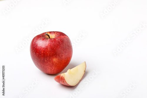 Red apple with slice on white background