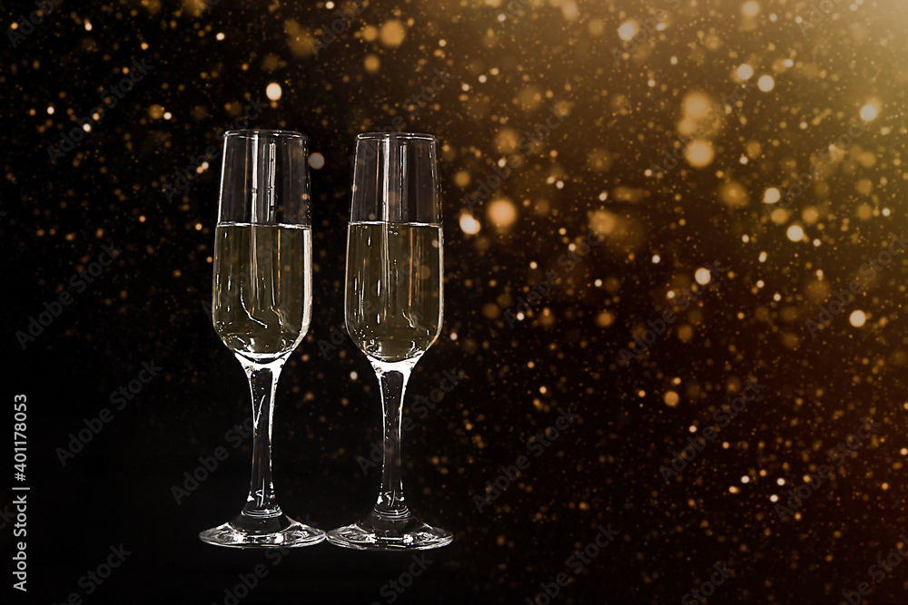 Wine glasses with champagne on a black background with fok