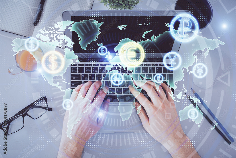 Double exposure of man's hands typing over laptop keyboard and forex chart hologram drawing. Top view. Financial markets concept. Double exposure of man's hands typing over laptop keyboard and forex chart hologram drawing. Top view. Financial markets concept.