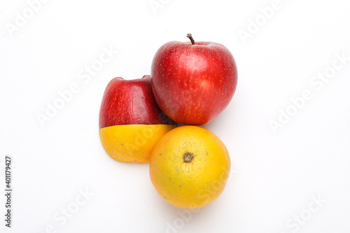 Stack of fresh fruits citrus slices, apple, orange or lemon. Colorful healthy fitness creative fun food concept. Mixed citrus fruit, apple isolated on white background