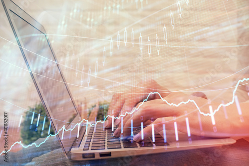 Multi exposure of woman hands typing on computer and forex chart hologram drawing. Stock market analysis concept.