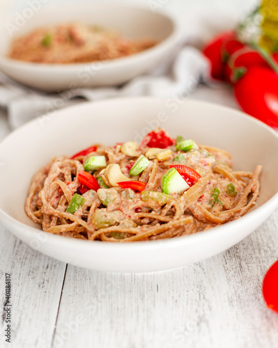 Pasta with walnut and cashew sauce with zucchini and cherry tomatoes
