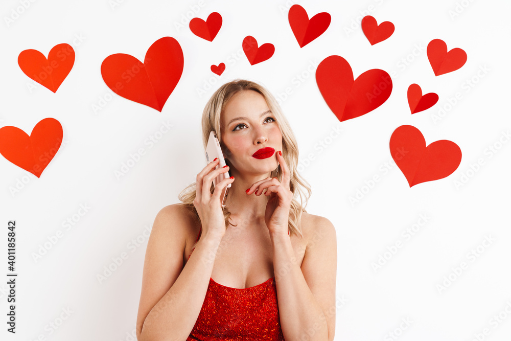 Beautiful young girl in dress looking upward and talking on cellphone Beautiful young girl in dress looking upward and talking on cellphone