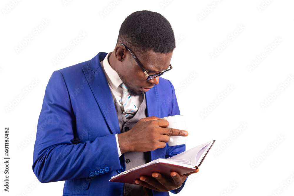 close-up of a young businessman with cup of coffee and agenda close-up of a young businessman with cup of coffee and agenda