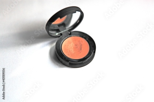  Isolated beauty compact make-up orange cream concealer with mirror on white background for self-care and fashion spa or professional application