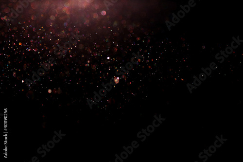 Festive glitter black and colourful lighting background. Shimmery colourful water drops for Christmas design