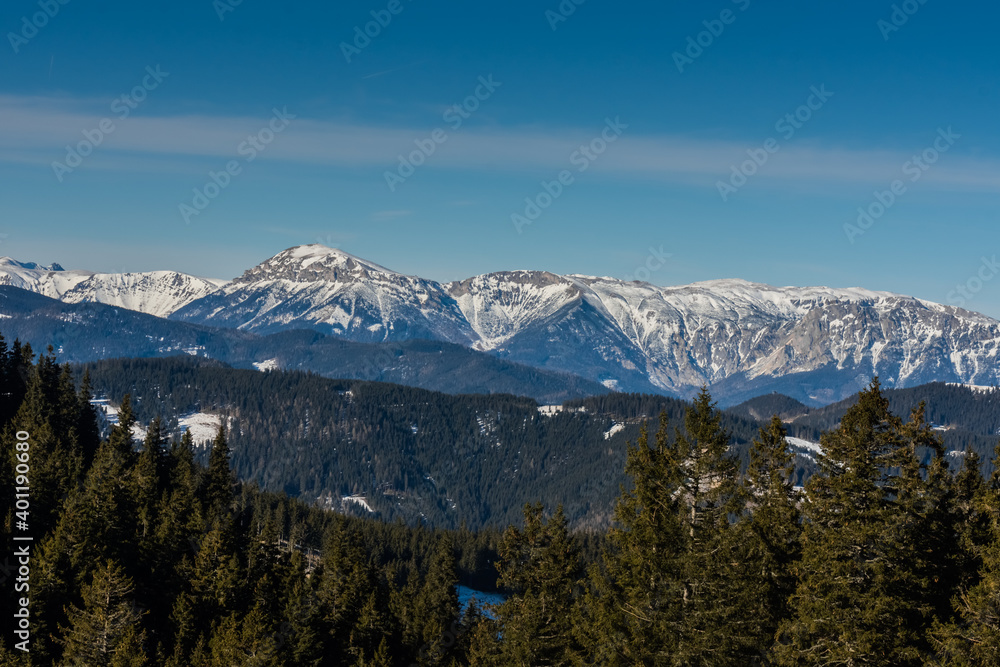 beautiful high mountains with snow and blue sky while hiking