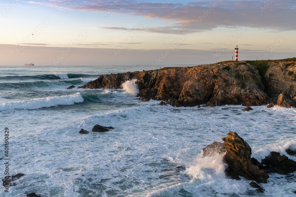 Obraz premium view of the Porto Covo lighthouse at sunset