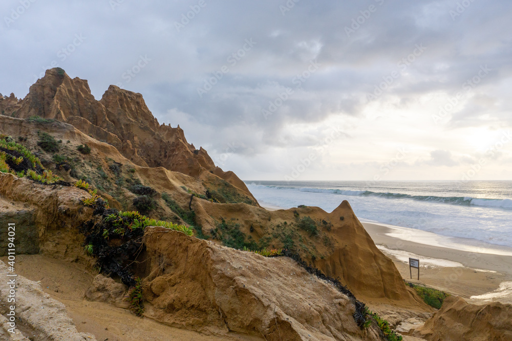 large sand dunes and broken up beach access road severely affected by wind and water erosion on the coast