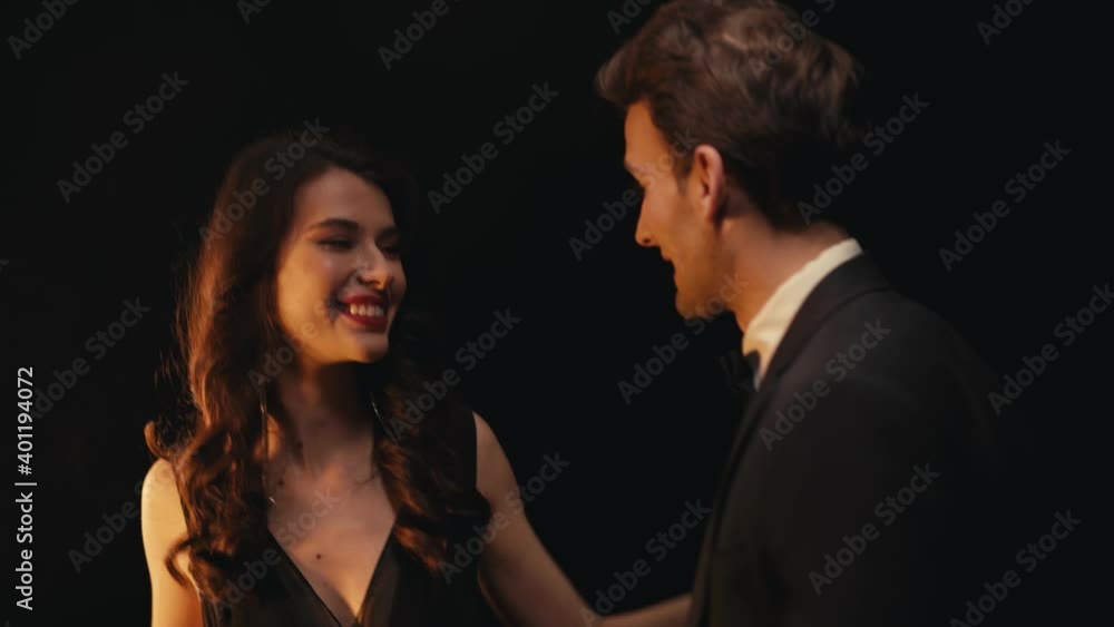 Happy elegant couple dancing isolated on black Happy elegant couple dancing isolated on black