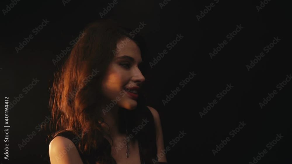 Happy young woman dancing isolated on black background Happy young woman dancing isolated on black background