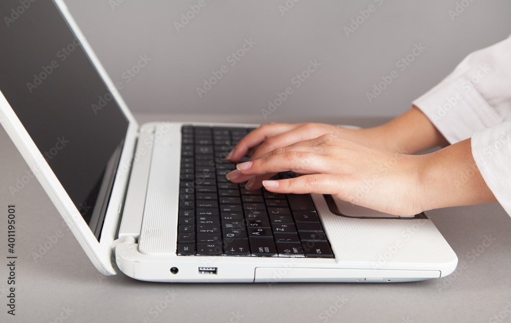 Female hands on a white computer keyboard. Female hands on a white computer keyboard.