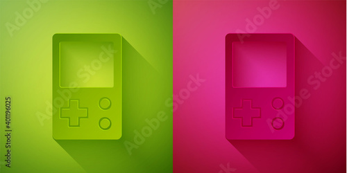 Paper cut Portable tetris electronic game icon isolated on green and pink background. Vintage style pocket brick game. Interactive playing device. Paper art style. Vector.