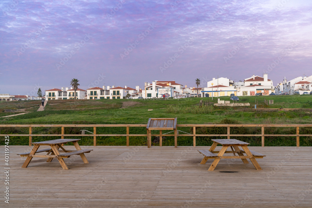 Fototapeta premium the scenic viewpoint on the Alentejo coast with the town of Porto Covo behind at sunset