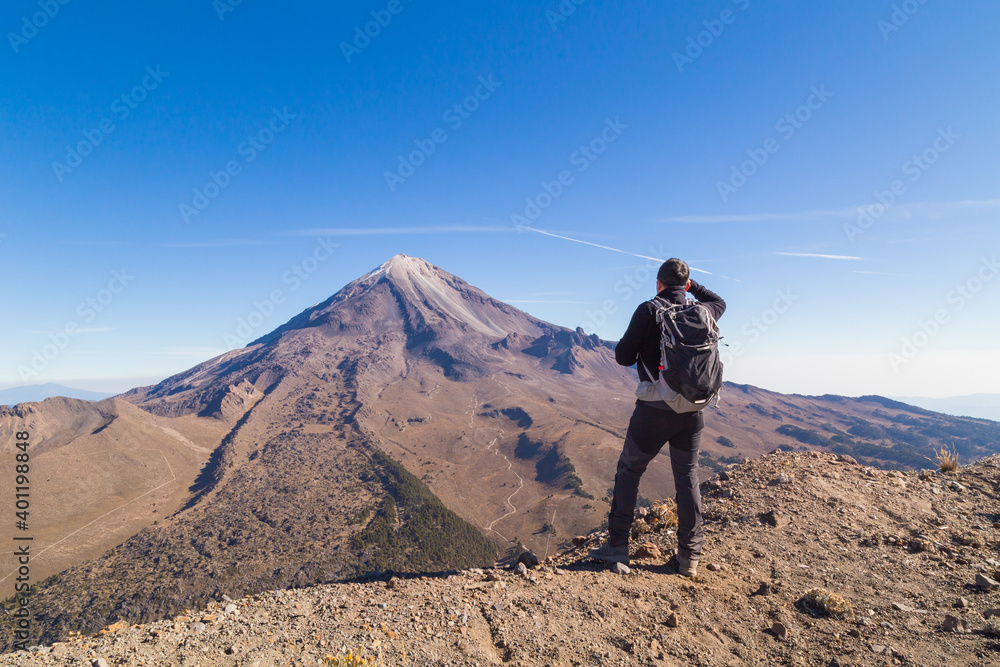 A beautiful shot of a male standing in Pico de Orizaba Volcano in Mexico A beautiful shot of a male standing in Pico de Orizaba Volcano in Mexico
