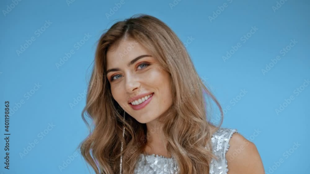 Smiling woman looking at camera isolated on blue Smiling woman looking at camera isolated on blue