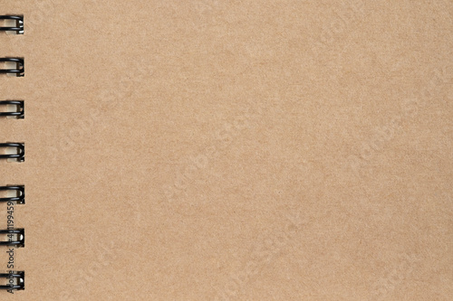 Blank, brown spiral notebook cardboard sheet. Paper craft abstract background. Retro, old vintage beige paper kraft pattern background. Design, minimal texture with empty, copy space for backdrop.