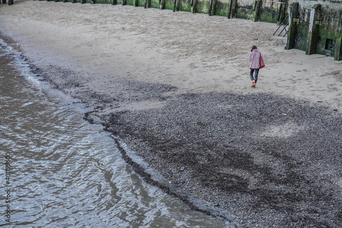 person walking on the beach
