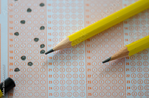 Close up of multiple choice examination form or  optical mark paper and yellow pencil photo