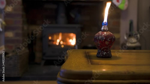 Burwood fragrance lamp burning flame with fire place in background, home concept. photo