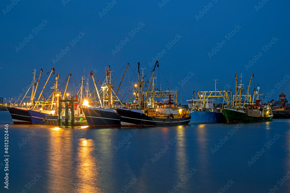 Fishing boats in the harbor from Lauwersoog in the Netherlands at night Fishing boats in the harbor from Lauwersoog in the Netherlands at night