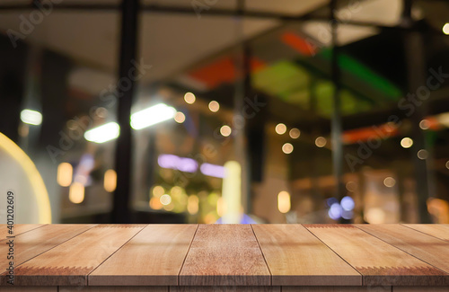 Wooden top table with bokeh light effect and blur restaurant on background, blur background.