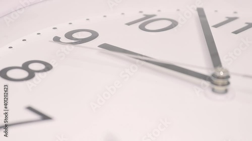 Wallpaper Mural The second hand moves along the dial of an analog clock close-up on a wooden background. Time. White dial, black numerals. Torontodigital.ca