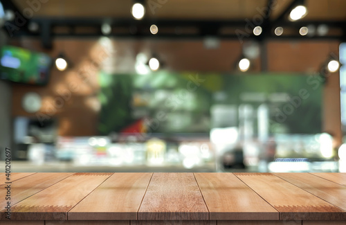 Wallpaper Mural Wooden top table with bokeh light effect and blur restaurant on background, blur background. Torontodigital.ca