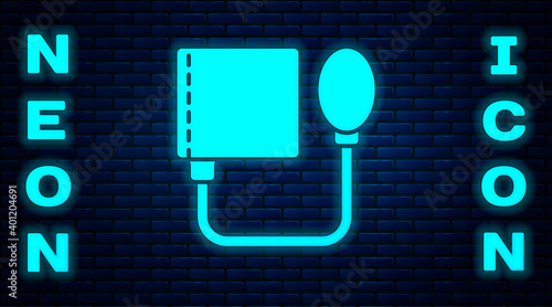 Glowing neon Blood pressure icon isolated on brick wall background. Vector.