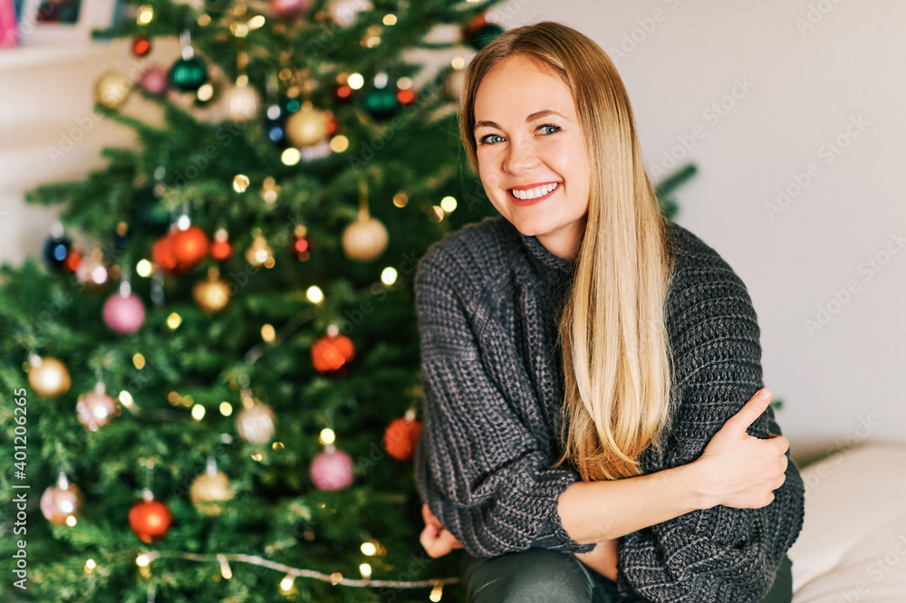 Christmas portrait of beautiful happy woman wearing warm cozy pullover Christmas portrait of beautiful happy woman wearing warm cozy pullover