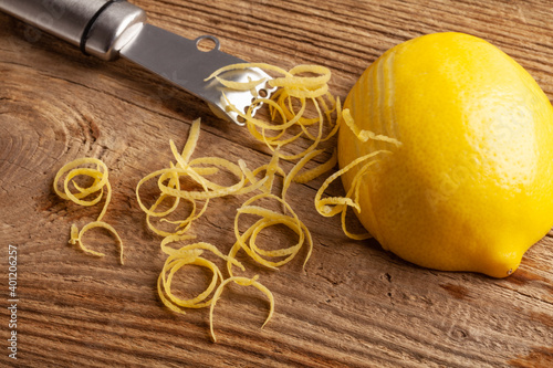 lemon zest and Zester on wooden board photo