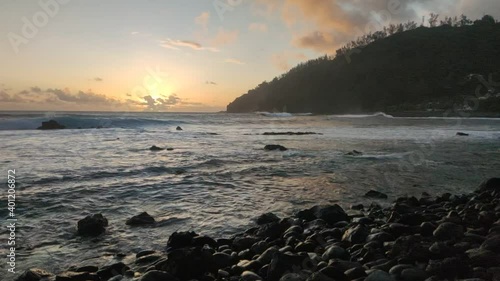 Sunset in Manapany bay, the southern part of Reunion Island, volcanic tropical paradise, France, Tropical Europe. photo