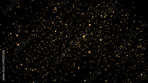 The dust is yellow. Yellow sparks and golden stars shine with special light. Vector sparkles on a black background. Christmas light effect. Sparkling magical dust particles