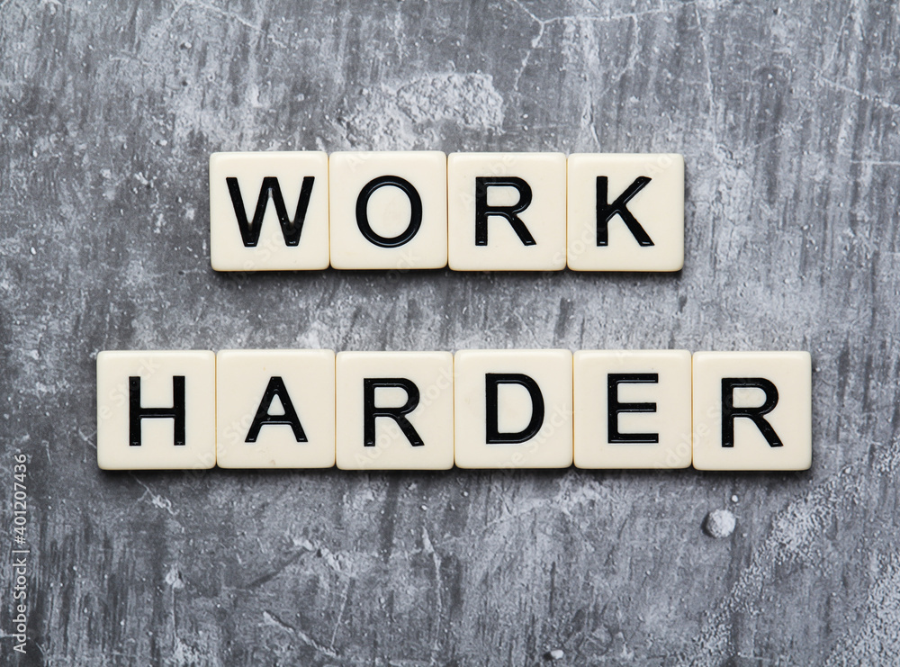 The motivating slogan Work Hard formed with tile letters The motivating slogan Work Hard formed with tile letters