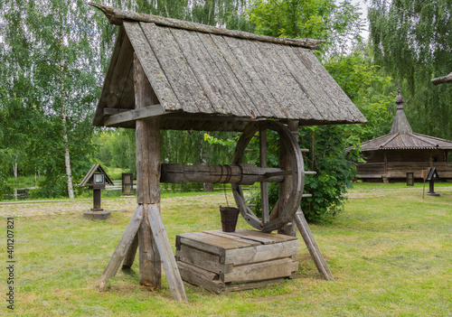 view of an old wooden well in the Russian Art Park in Kostroma, photo was taken on a cloudy summer day