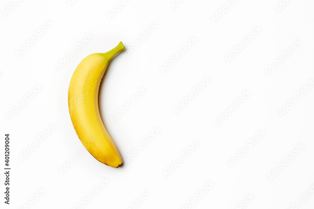 Single fresh raw clean isolated one alone vertically oriented yellow banana on the bright solid white fond background Single fresh raw clean isolated one alone vertically oriented yellow banana on the bright solid white fond background