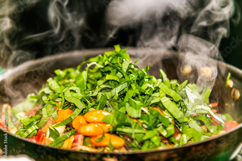 Fresh vegetables and herbs in a pan.Closeup