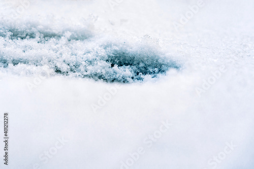 Ice on the snowy surface of an icy river, winter background