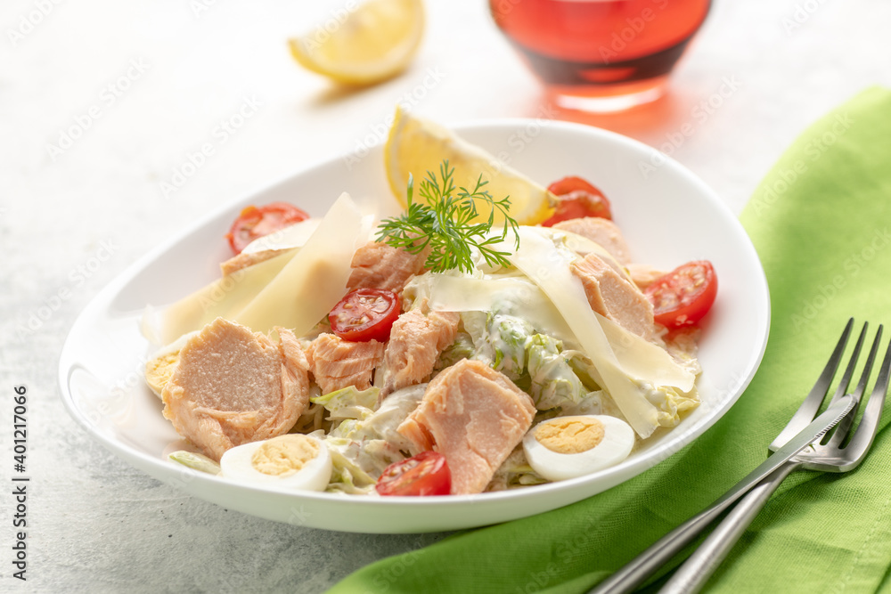 Salad with baked salmon. A large portion of salad with red fish, fresh vegetables, eggs, cherry tomatoes and lemon. Salad with baked salmon. A large portion of salad with red fish, fresh vegetables, eggs, cherry tomatoes and lemon.