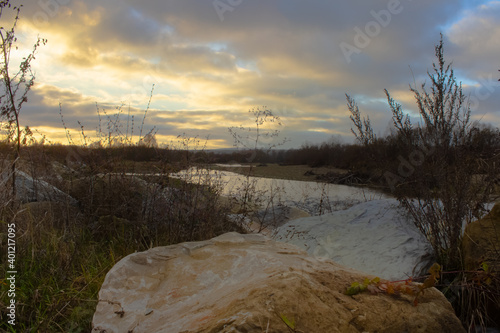  sunset on the rocky bank of a mountain river in autumn