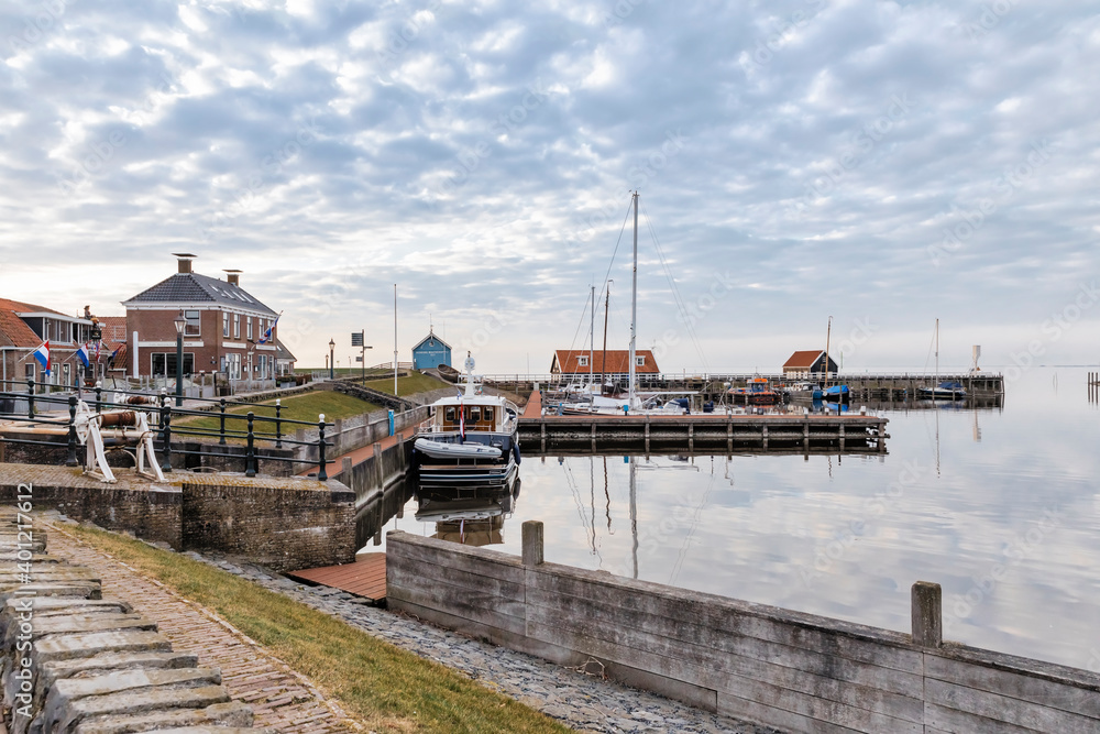 Old harbor with sluice and buildings in Hindeloopen, Netherlands