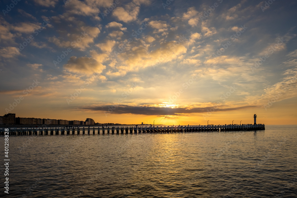 Sunset over the old wooden pier of Nieuwpoort, Belgium.