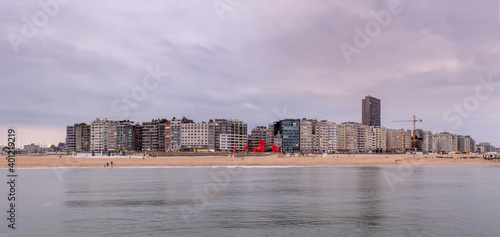 Skyline of Ostend (Belgium) against cloudy sky after sunset.