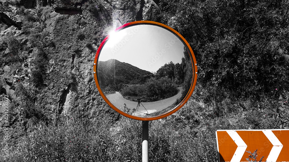 Road mirror. Round mirror placed on the turn on the road for safe