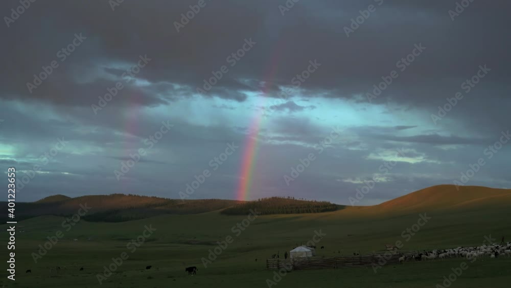 Rainbow in the Mongolian meadows at sunrise.Sunup at dawn twilight early morning day before after time Mongolia Mongolian Siberian Siberia Central Asia grassland prairie moorland meadow wold pasture Rainbow in the Mongolian meadows at sunrise.Sunup at dawn twilight early morning day before after time Mongolia Mongolian Siberian Siberia Central Asia grassland prairie moorland meadow wold pasture