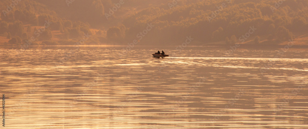Fototapeta premium Fishing boat on the lake in the morning. Banner, wide format