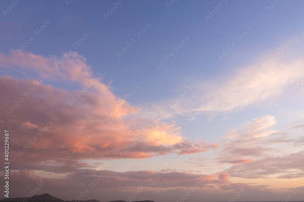 color of the pinky sky and soft warm color clouds in dawn time, sunrise morning over. skies covered by romantic cirrus clouds, nature background of Samui island in Thailand. beautiful nature seascape.