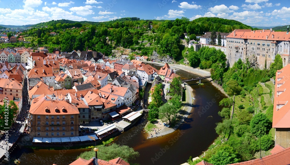 Panoramic view of the historic center of Cesky Krumlov, Czech Republic. View from the castle tower, red roofs of historic houses, the Vltava river, the castle and chateau.