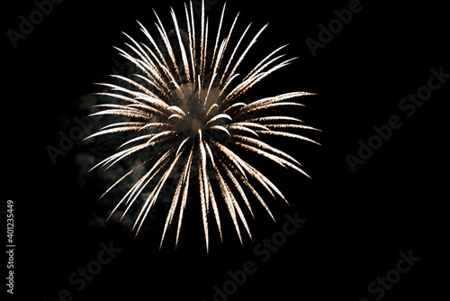 exploding firework rocket with white stripes, black nightly sky with copy space, silvester midnight