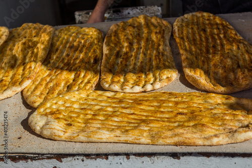 Yellow baked Barbari bread,one of the thickest flat breads,  on the food stall in Shirazi, Iran